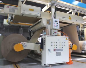 Mill Roll Stand for unwinding paper reels under smooth tension control.